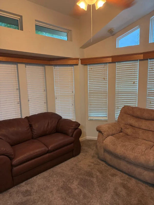 The living room of the park model, with a vaulted ceiling and bay windows